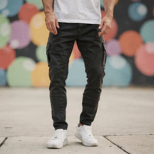 View of slim fit super stretch cargo trousers in dark grey, featuring multiple pockets and a comfortable waistband