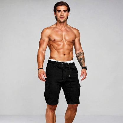 View of relaxed fit baggy cargo shorts in olive green, featuring a drawstring waist and multiple pockets