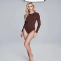 View of a black long sleeve bodysuit made from soft, stretchy fabric with a slim fit silhouette