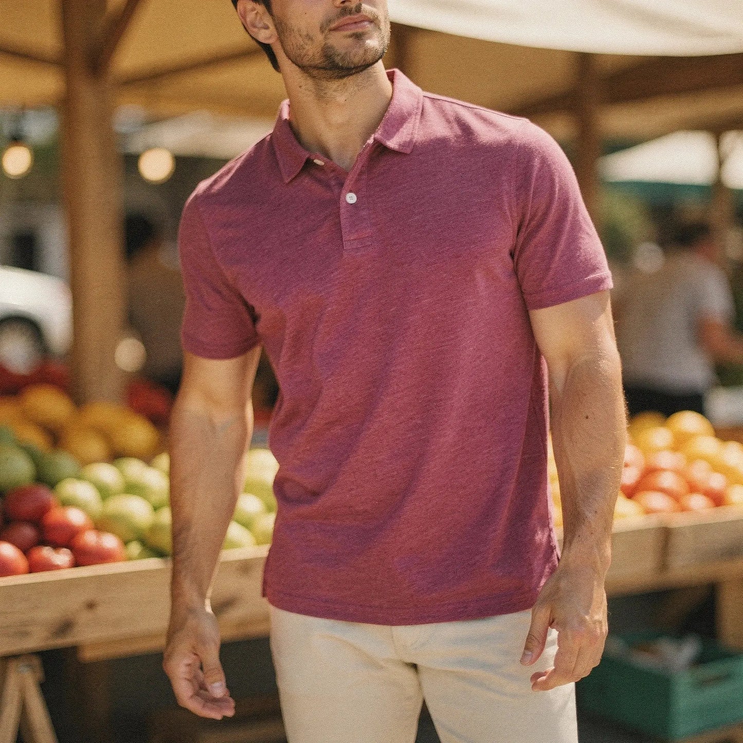 View of a navy blue slim fit short sleeve polo shirt featuring a V neck and soft cotton material
