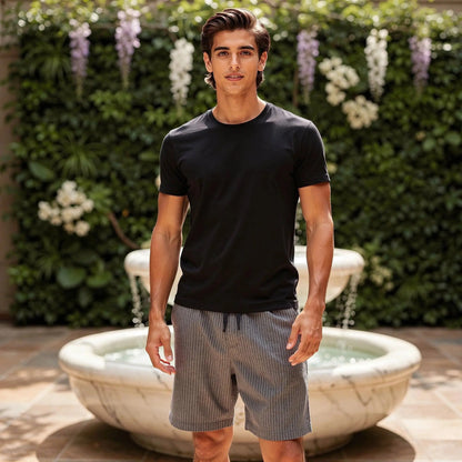View of relaxed fit summer shorts featuring blue and white stripes, drawstring waist, and lightweight fabric
