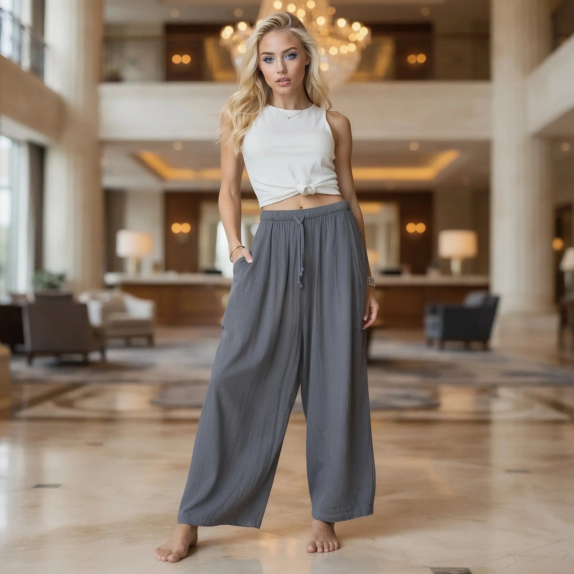 View of relaxed fit high rise wide leg comfort pants in soft beige fabric, showcasing the waistband and pocket design