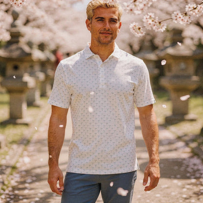 View of a relaxed fit short sleeve golf polo in light blue, featuring a crew neck and soft fabric