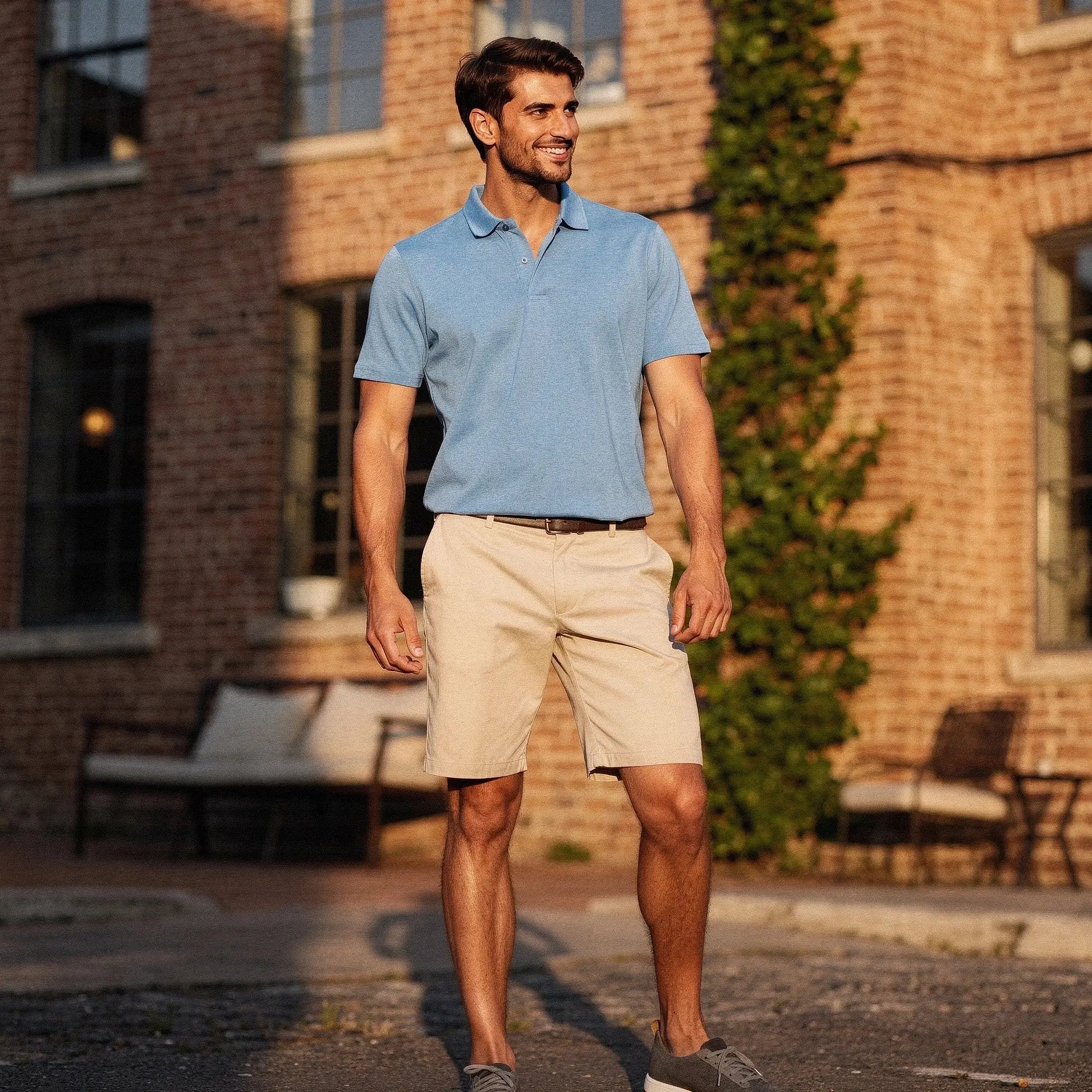 View of a navy blue slim fit short sleeve polo shirt with a V neck, made