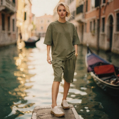 View of a relaxed fit crew neck midi dress in soft cotton, featuring short sleeves and a flowing silhouette in a light pastel color