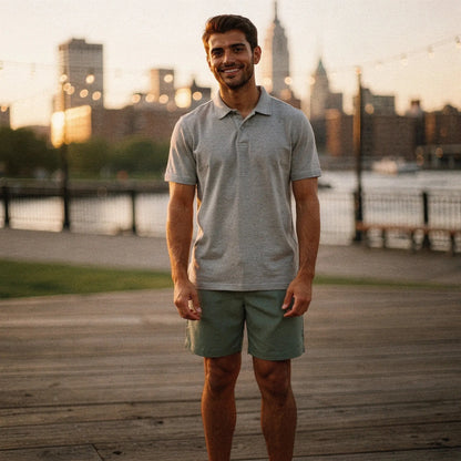 View of a navy blue slim fit short sleeve polo shirt with a V neck and soft cotton material