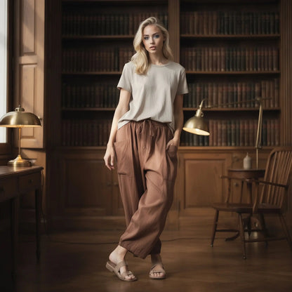 View of relaxed fit high rise wide leg comfort pants in soft beige fabric, showcasing the waistband and pocket design