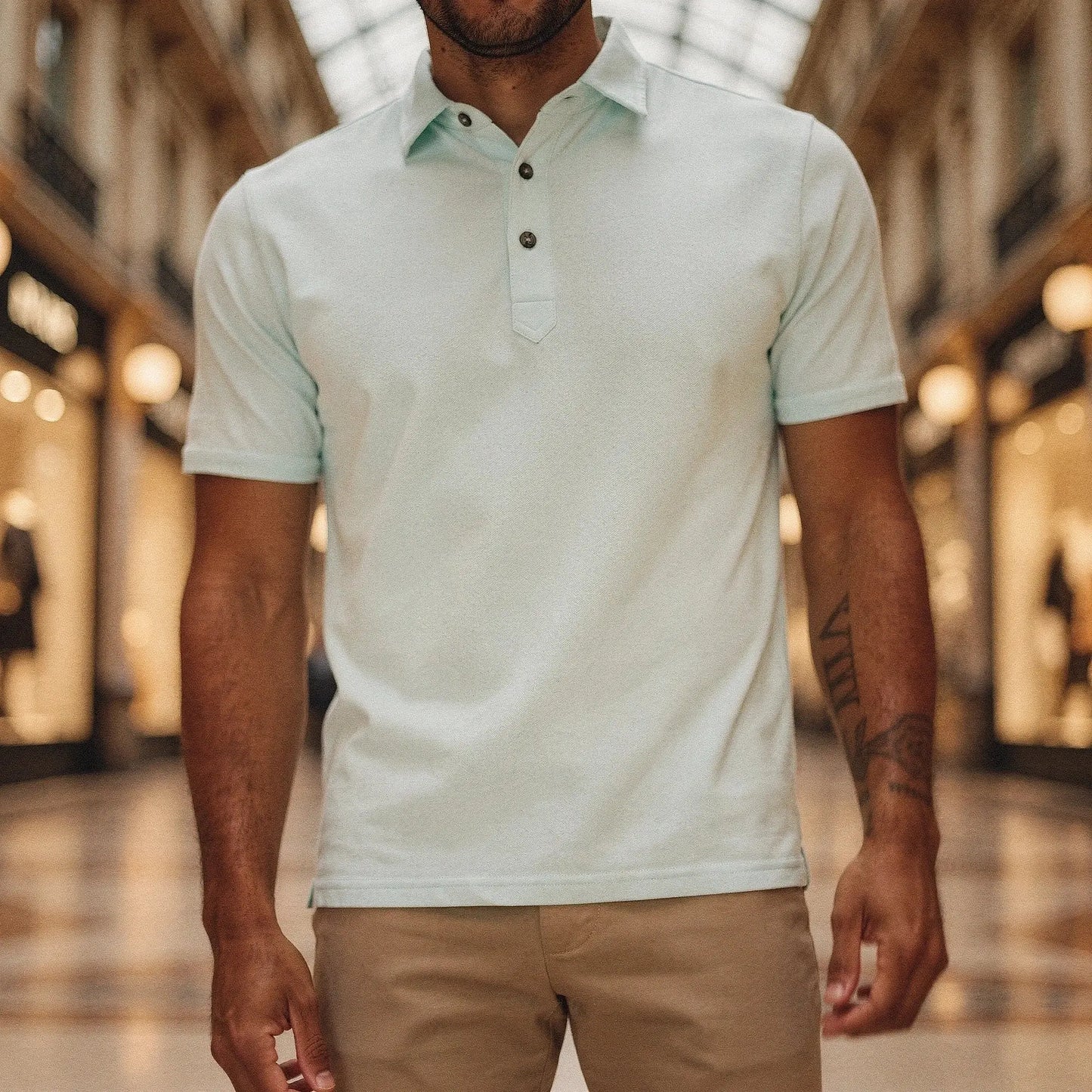 Light grey slim fit short sleeve polo shirt with a V neck, featuring a soft cotton blend and detailed stitching