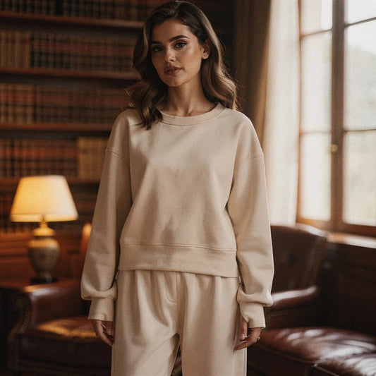 View of a relaxed fit crew neck long sleeve sweatshirt in soft gray fabric, featuring a simple design and comfortable silhouette