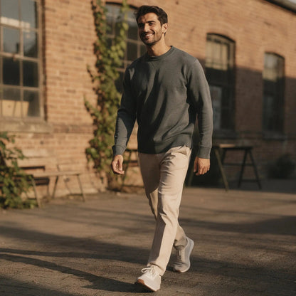 View of a gray relaxed fit crew neck long sleeve sweatshirt, showcasing soft fabric and ribbed cuffs
