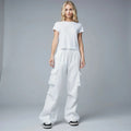 View of relaxed fit wide leg cargo pants in olive green, featuring multiple pockets and a comfortable waistband