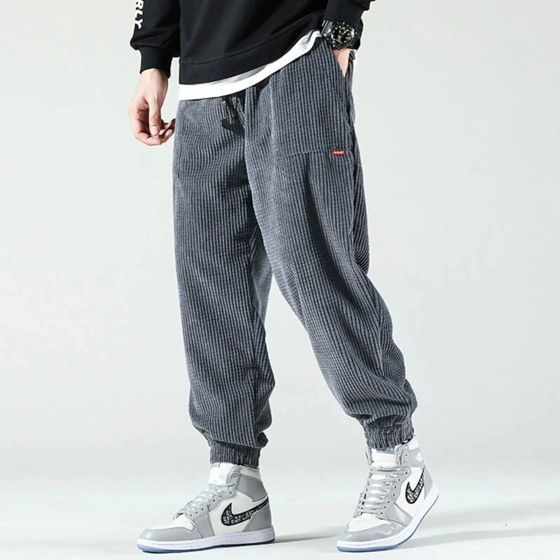 View of relaxed fit tapered joggers in soft beige corduroy with a drawstring waist and pockets
