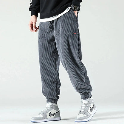 View of relaxed fit tapered joggers in soft beige corduroy with a drawstring waist and pockets