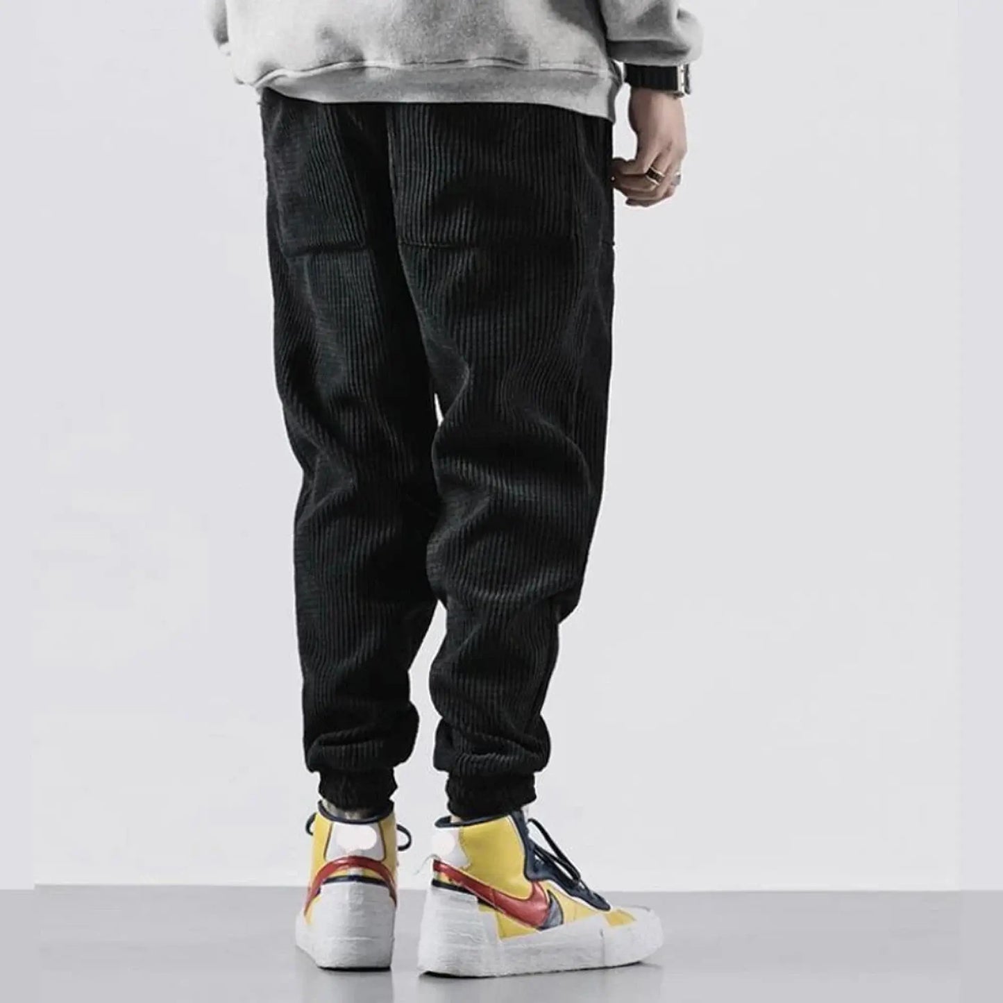 View of relaxed fit tapered joggers in soft tan corduroy, featuring a drawstring waistband and pockets