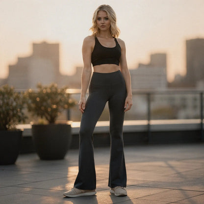 View of high waist flared bootcut yoga pants in soft black fabric, showcasing the wide waistband and flowing leg design