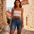 View of high waist stretch fit Bermuda jean shorts in light blue denim, featuring a casual everyday design