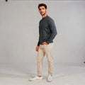 View of a relaxed fit crew neck long sleeve casual sweatshirt in light gray, featuring ribbed cuffs and a soft fabric
