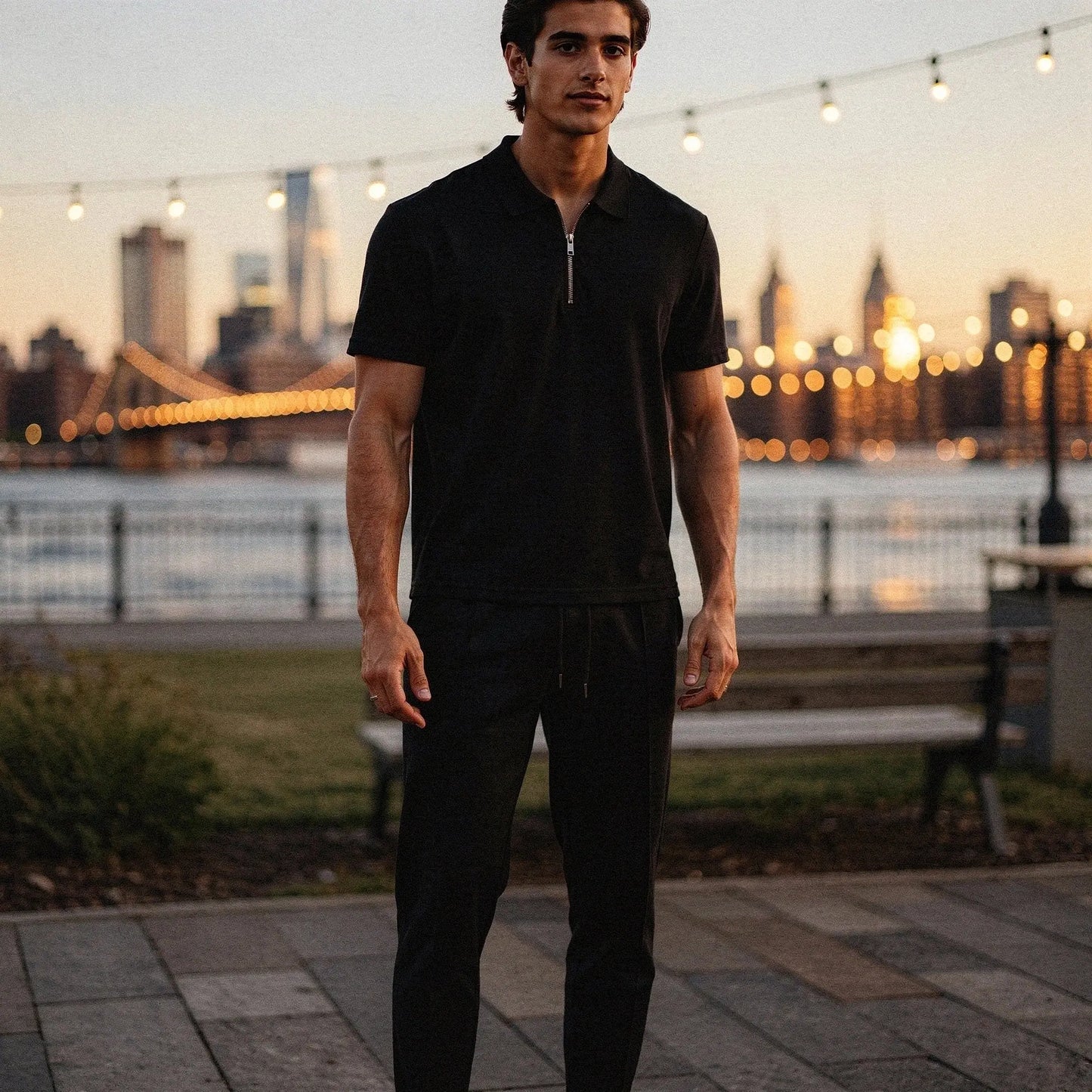 View of a slim fit short sleeve sport suit set in dark gray, featuring a zippered and lightweight fabric