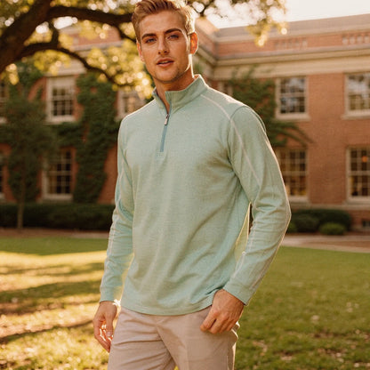 View of a lightweight, slim fit quarter zip layer in dark gray, featuring a smooth fabric and minimalistic design