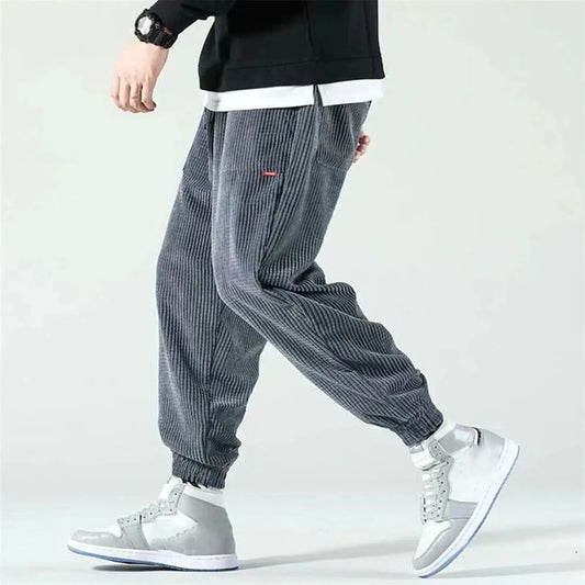 View of relaxed fit tapered drawstring baggy joggers in soft beige corduroy with elastic waistband and pockets