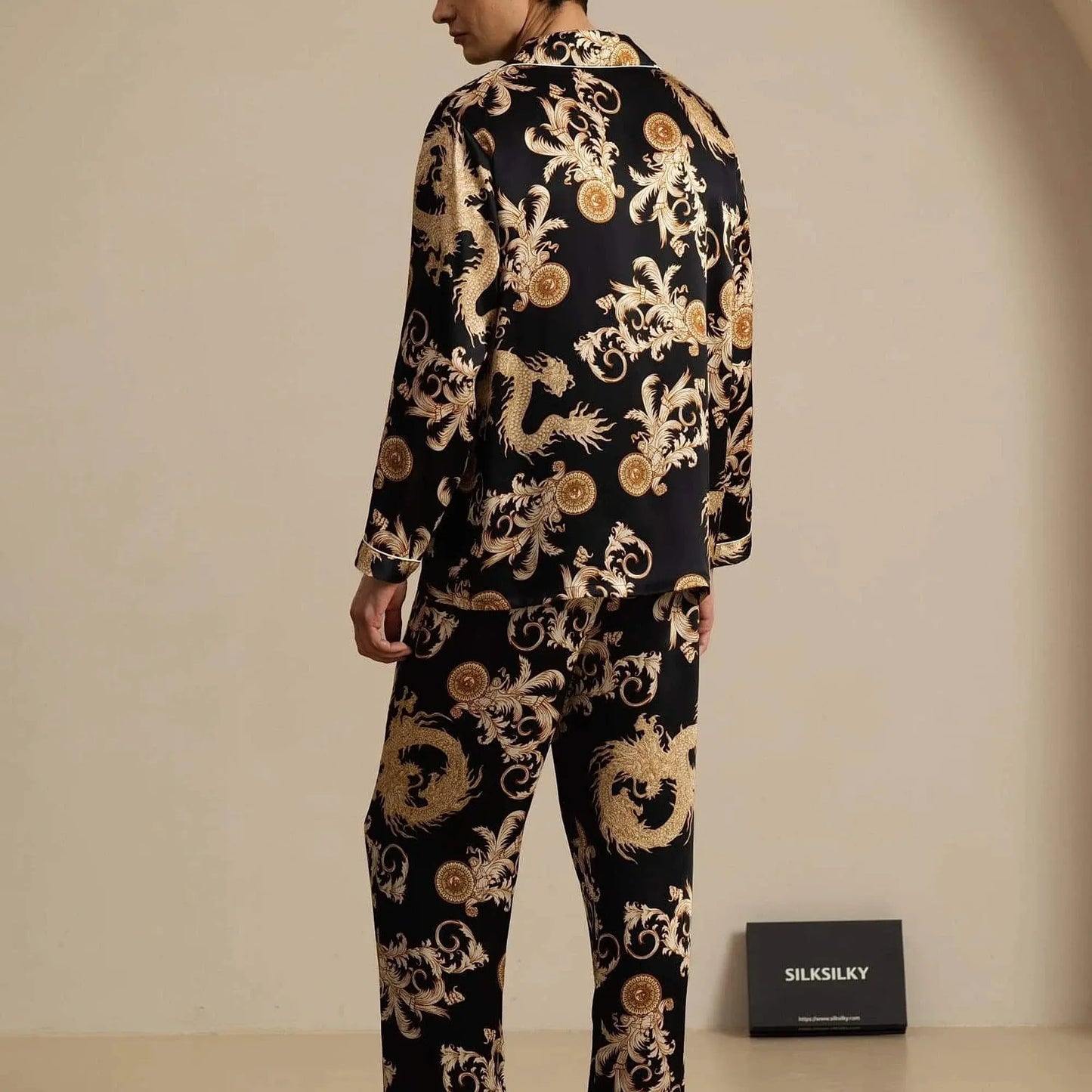 View of relaxed fit long sleeve silk pajamas set in soft navy blue, featuring a notch collar and elegant sheen