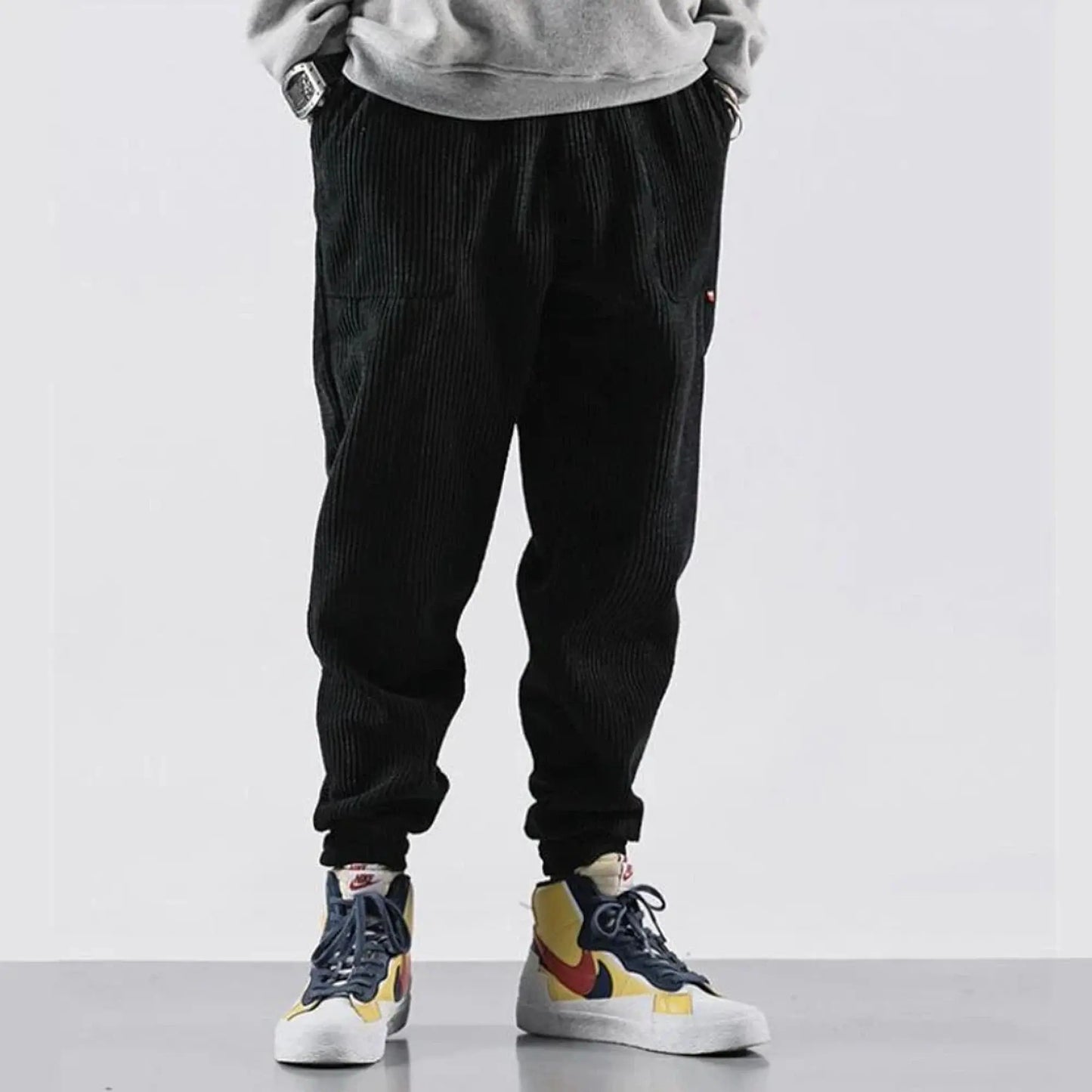 View of relaxed fit tapered joggers in soft tan corduroy, featuring a drawstring waistband and pockets