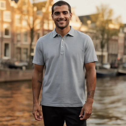 View of a navy blue slim fit short sleeve polo shirt featuring a V neck and soft cotton material