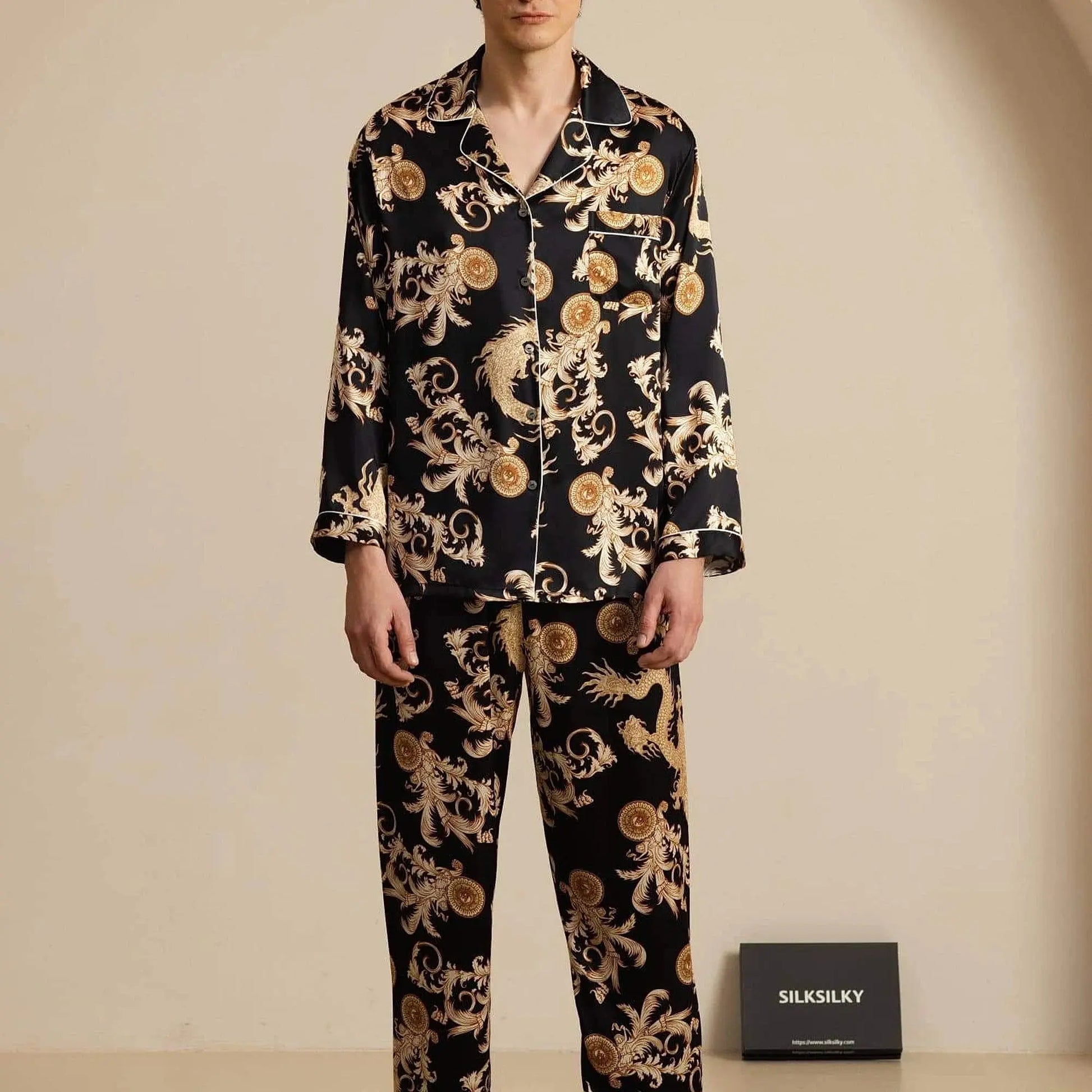 View of relaxed fit long sleeve silk pajamas set in deep navy with notch collar and contrasting piping