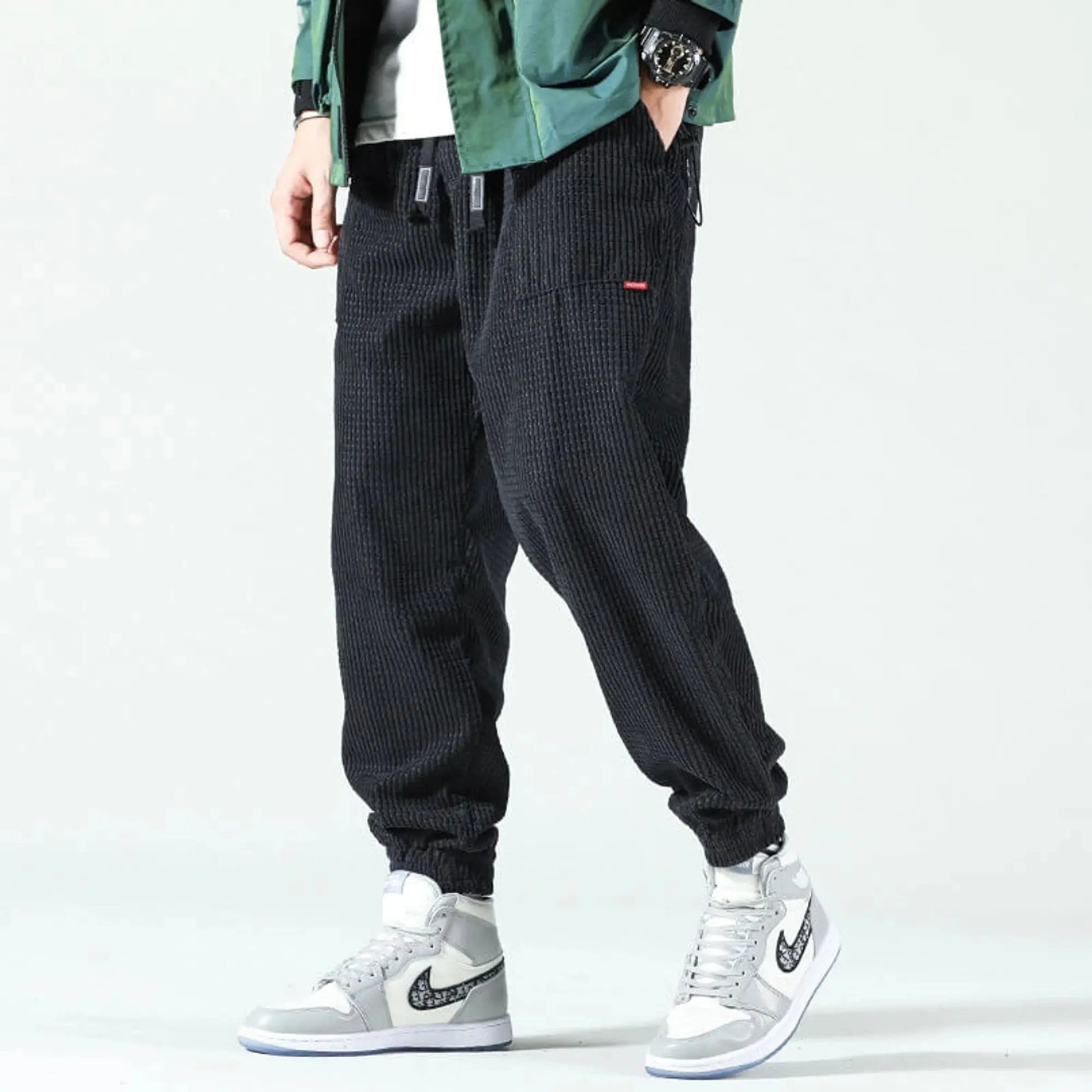 View of relaxed fit tapered joggers in soft beige corduroy, featuring a drawstring waistband and pockets