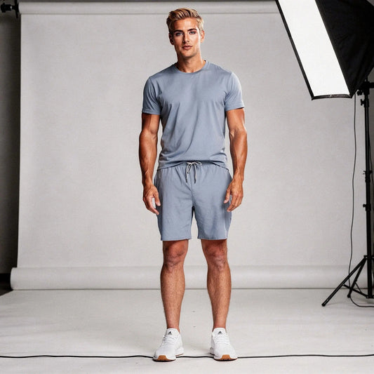 View of gray men's relaxed fit workout shorts featuring an elastic waistband and 7 inch inseam