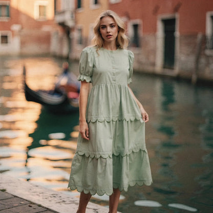 View of a light blue flowy A line midi dress featuring a round neck and short sleeves, made