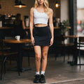 View of a relaxed fit A line skirt in light gray, featuring pockets and above the knee length