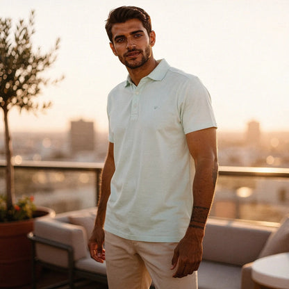 View of a navy blue slim fit short sleeve polo shirt featuring a V neck and soft cotton material