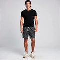 View of relaxed fit summer shorts featuring a striped pattern, drawstring waist, and lightweight fabric in shades of blue and white