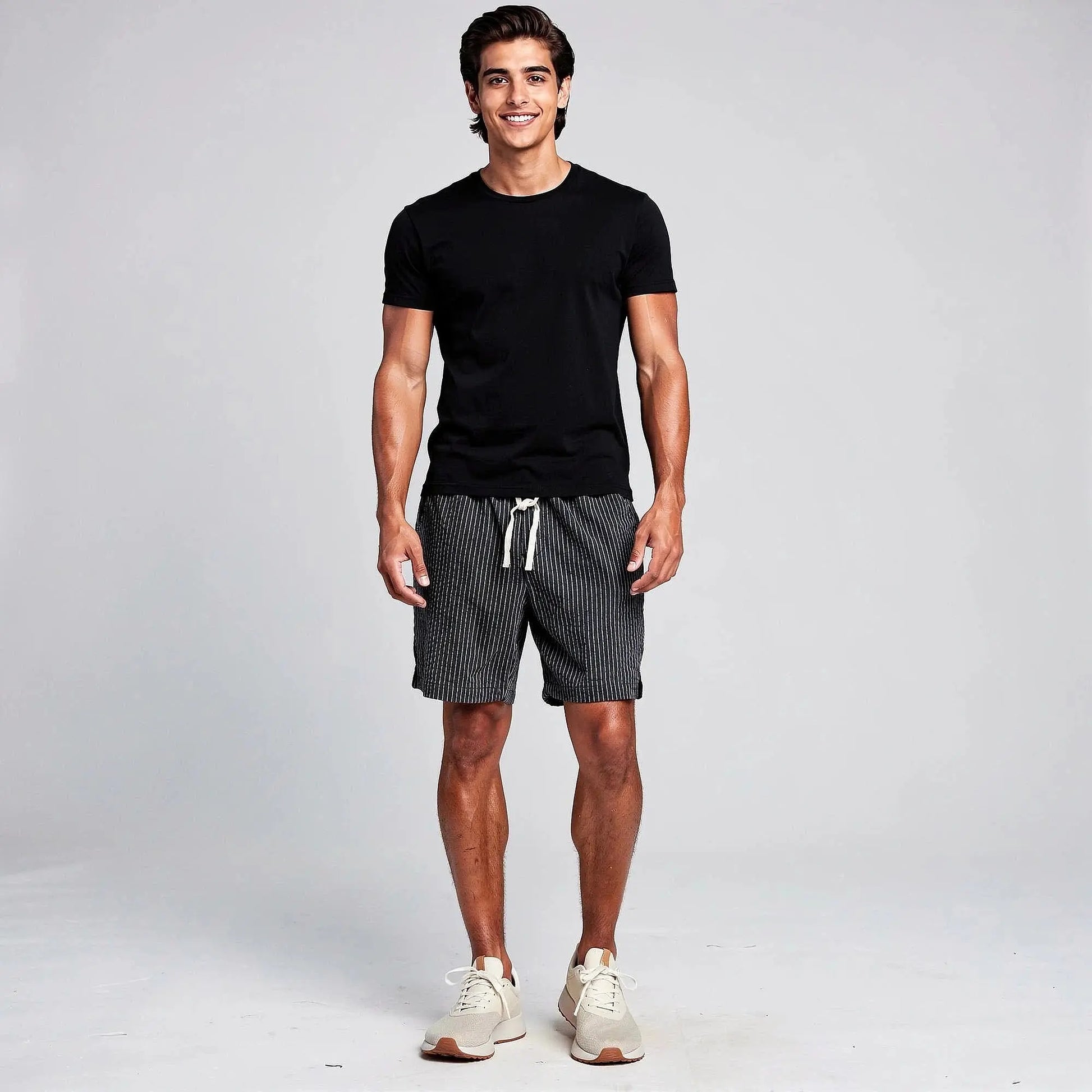 View of relaxed fit summer shorts featuring a striped pattern, drawstring waist, and lightweight fabric in shades of blue and white