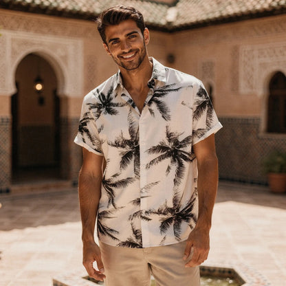 View of a slim fit short sleeve Hawaiian shirt featuring a vibrant floral pattern in shades of blue and green