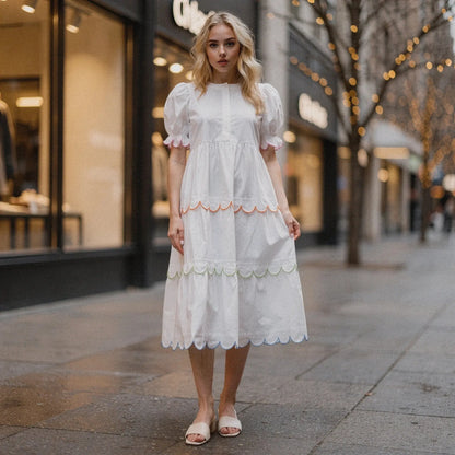 Light blue flowy A line midi dress with a round neck and short sleeves, view showcasing the fabric and drape