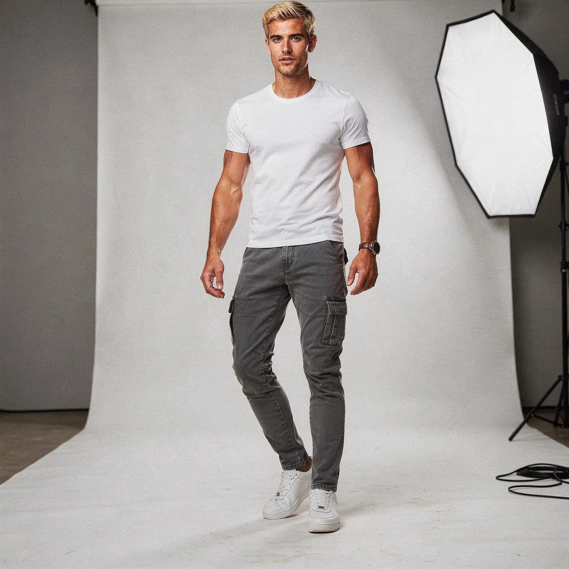 View of slim fit super stretch cargo trousers in dark gray, featuring multiple pockets and a comfortable waistband