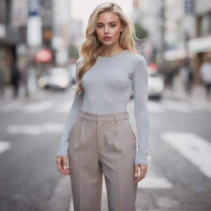 View of a black long sleeve bodysuit made from soft, stretchy fabric featuring a slim fit and high neckline