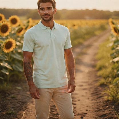 View of a navy blue slim fit short sleeve polo shirt featuring a V neck and soft cotton fabric